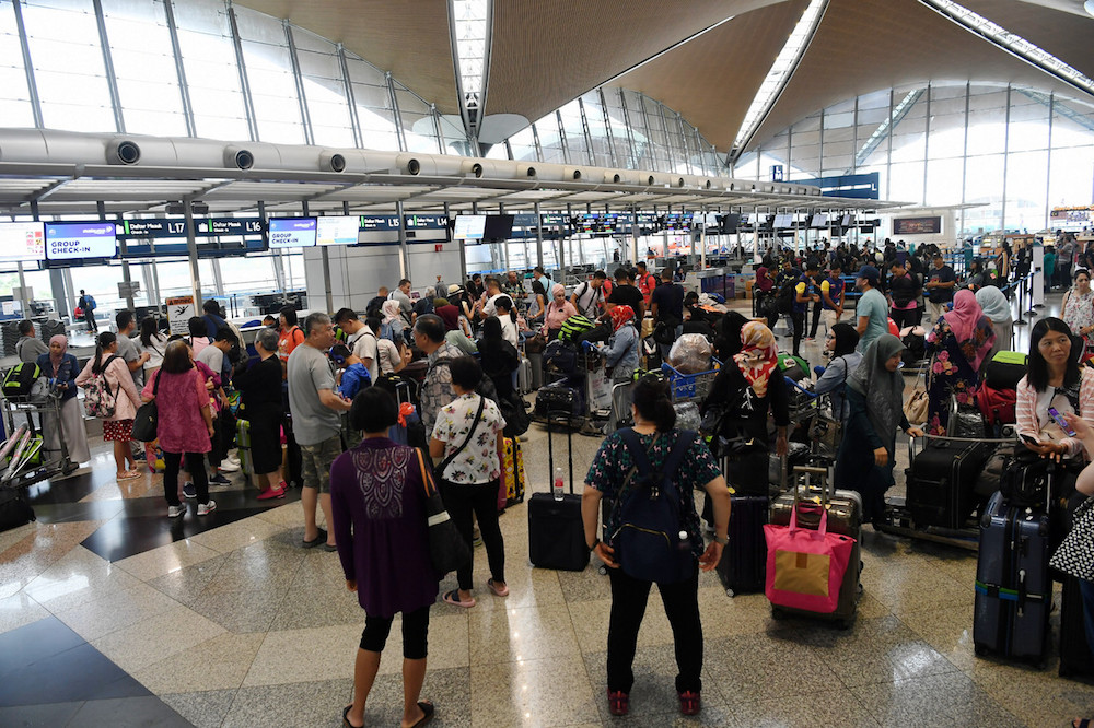 Passengers are seen at KLIA in Sepang August 22, 2019, during a systems outage. u00e2u20acu201d Bernama pic