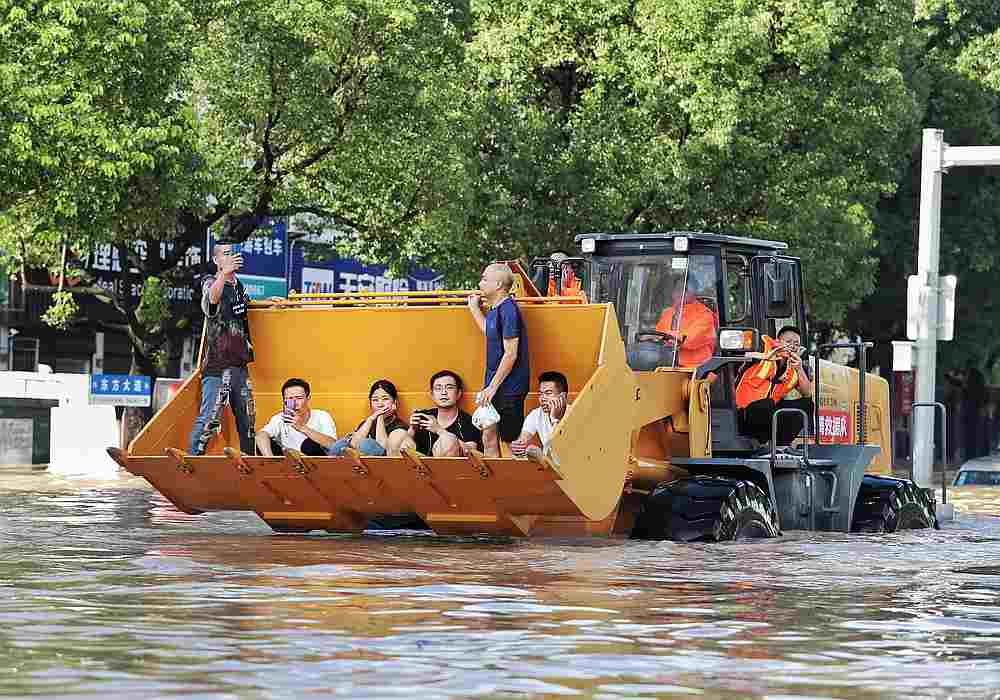 Rescue workers evacuate stranded residents with a bulldozer on a flooded street after typhoon Lekima hit Taizhou, Zhejiang province, China August 11, 2019. u00e2u20acu201d Reuters pic