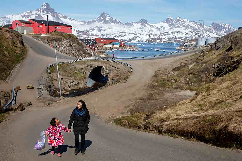 A woman and child hold hands as they walk on the street in the town of Tasiilaq, Greenland June 15, 2018. u00e2u20acu201d Reuters pic