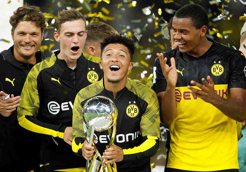 Borussia Dortmund's Jadon Sancho celebrates with the trophy after winning the German Super Cup against Bayern Munich at Signal Iduna Park, Dortmund August 3, 2019. u00e2u20acu201d Reuters pic