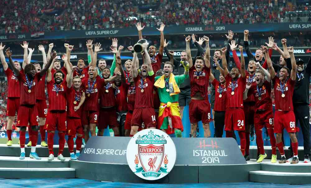 Liverpool's Jordan Henderson lifts the trophy as he celebrates winning the Uefa Super Cup with team mates, August 14, 2019. u00e2u20acu2022 Reuters pic 