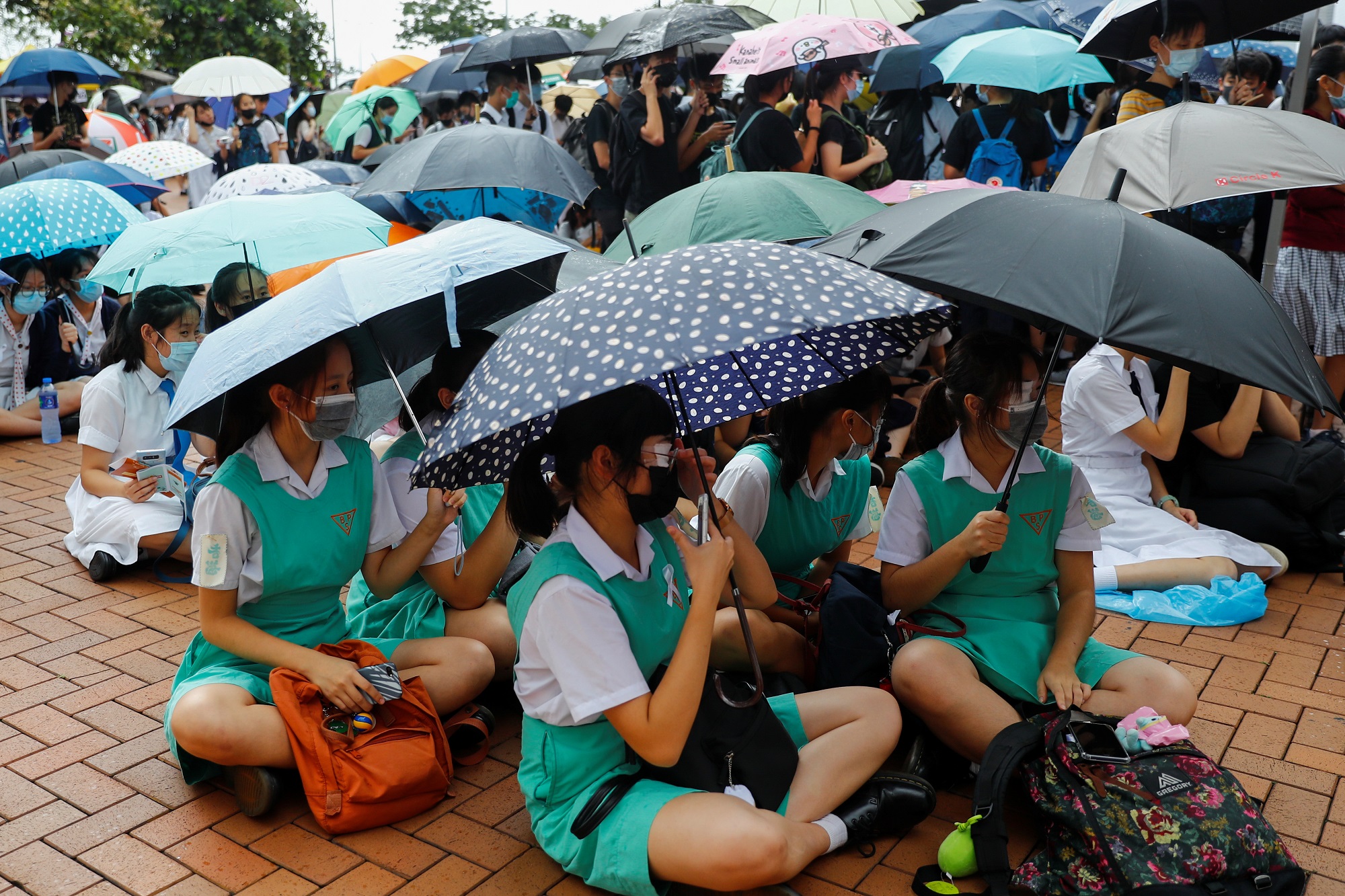 Students hold umbrellas as they protest at Edinburgh Place in Hong Kong, China September 2, 2019. REUTERS/Kai Pfaffenbach