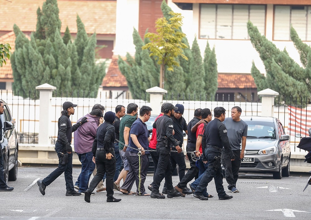 Six personnel from the National Registration Department is led to George Town Sessions Court September 12, 2019. u00e2u20acu201d Picture by Sayuti Zainudin