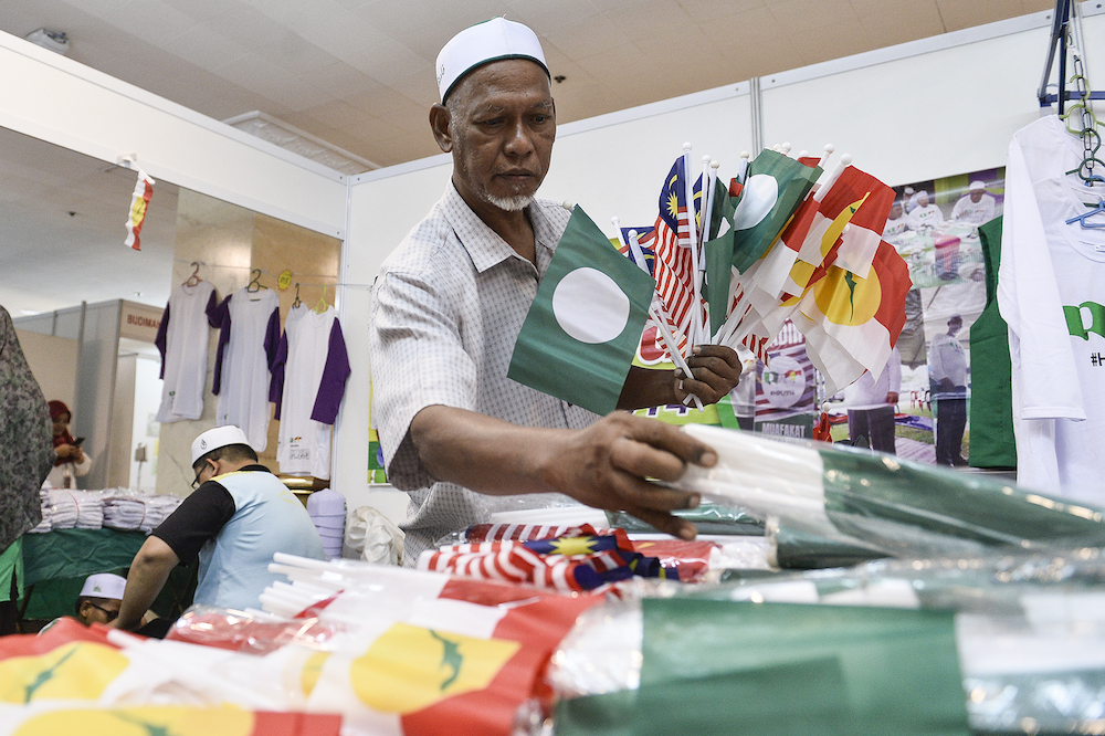 A man sells PAS-Umno flags during Himpunan Penyatuan Ummah (Muslim Unity Rally) at Putra World Trade Centre in Kuala Lumpur September 13, 2019. u00e2u20acu201d Picture by Miera Zulyana