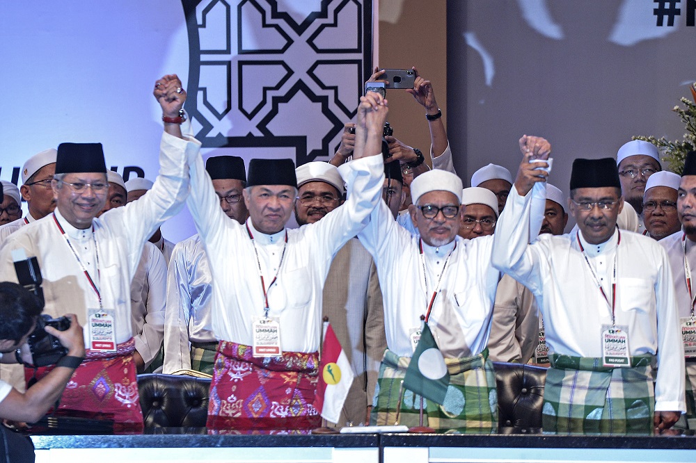 Umno president Datuk Seri Zahid Hamidi (second left) and PAS president Datuk Seri Hadi Awang (second right) at the Himpunan Penyatuan Ummah held at the Putra World Trade Centre in Kuala Lumpur September 14, 2019. u00e2u20acu201d Picture by Shafwan Zaidon