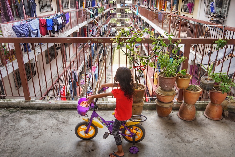 A girl rides a bicycle in the corridor of a low-cost flat in Kuala Lumpur September 29, 2019. u00e2u20acu201d Picture by Ahmad Zamzahuri