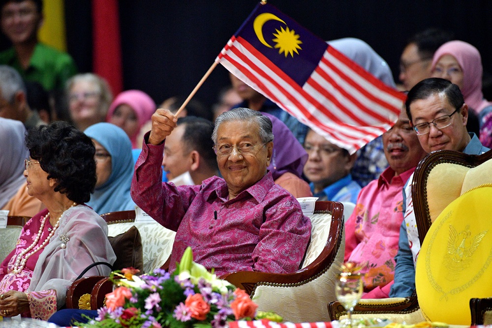 Prime Minister Tun Dr Mahathir Mohamad smiles as he waves the National flag during the Malaysia Day celebrations in Kuching September 16, 2019. u00e2u20acu201d Bernama pic