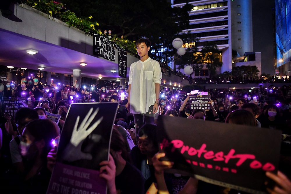 This photo taken on August 28, 2019 shows Cantopop singer, actress and LGBT activist Denise Ho posing with protesters during a #MeToo rally calling on police to answer accusations of sexual violence against pro-democracy protesters in Hong Kong. u00e2u20acu2022 AFP p