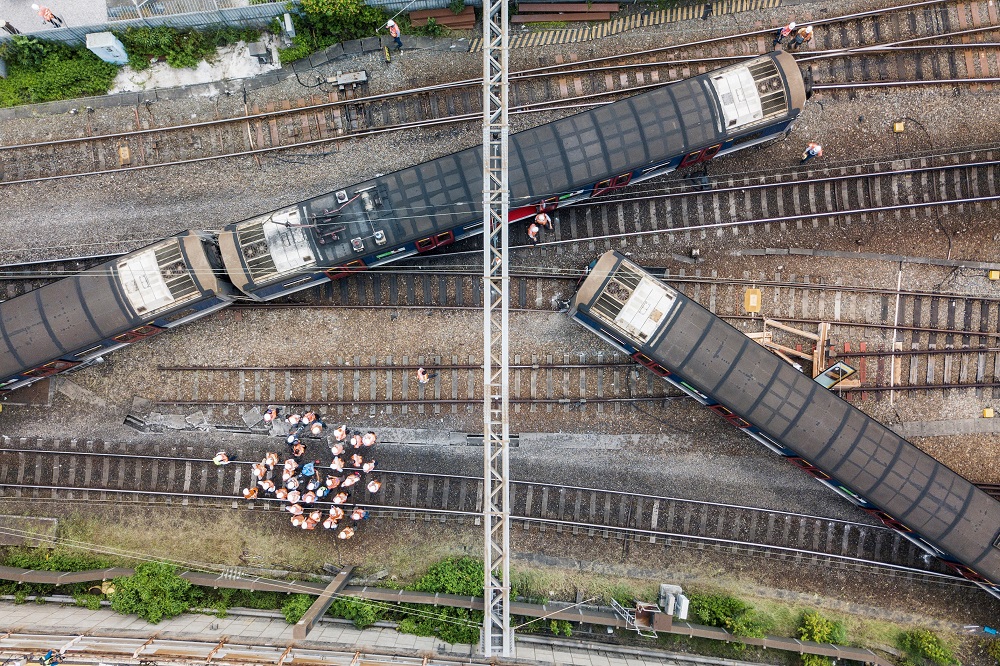 This aerial picture shows rescue workers standing on a railway track near a passenger train, after it derailed during rush hour outside Hung Hom station on the Kowloon side of Hong Kong September 17, 2019. u00e2u20acu201d AFP pic          