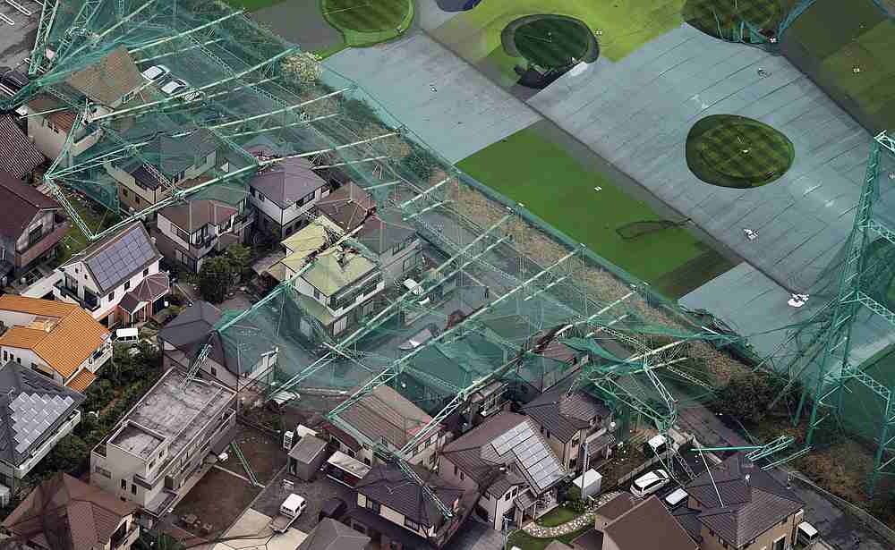 Houses damaged by a collapse of the perimeter netting of a golf training field due to strong winds of Typhoon Faxai in Ichihara, east of Tokyo, Japan September 9, 2019. u00e2u20acu201d Kyodo pic via Reuters