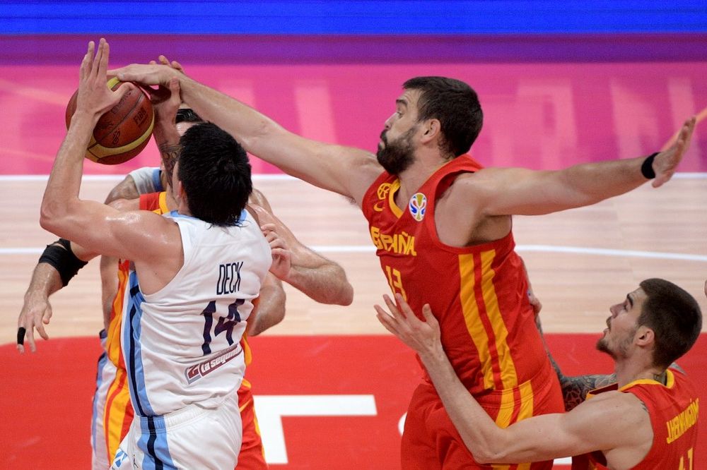 Spainu00e2u20acu2122s Marc Gasol (centre) fights for the ball with Argentinau00e2u20acu2122s Gabriel Deck during the Basketball World Cup final game between Argentina and Spain in Beijing on September 15, 2019. u00e2u20acu201d AFP pic