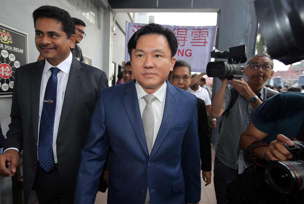 DAP lawmaker Paul Yong arrives at the Sessions Court in Ipoh, accompanied by Buntong and Pokok Assam assemblymen A. Sivasubramaniam (left) and Leow Thye Yih (right) September 24, 2019. u00e2u20acu2022 Picture by Farhan Najib