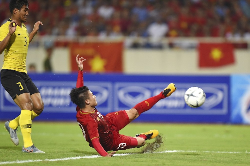 Vietnamu00e2u20acu2122s Nguyen Quang Hai scores the goal against Malaysia during their Qatar 2022 World Cup qualifying match at My Dinh stadium in Hanoi October 10, 2019. u00e2u20acu201d AFP pic