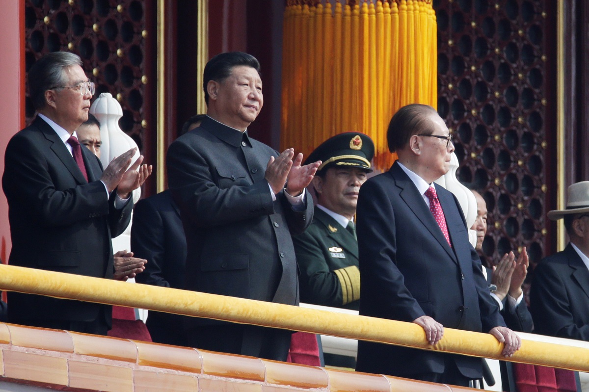 Chinese President Xi Jinping applauds as he stands between former presidents Hu Jintao and Jiang Zemin on Tiananmen Gate before the military parade marking the 70th founding anniversary of People's Republic of China, on its National Day in Beijing, China 