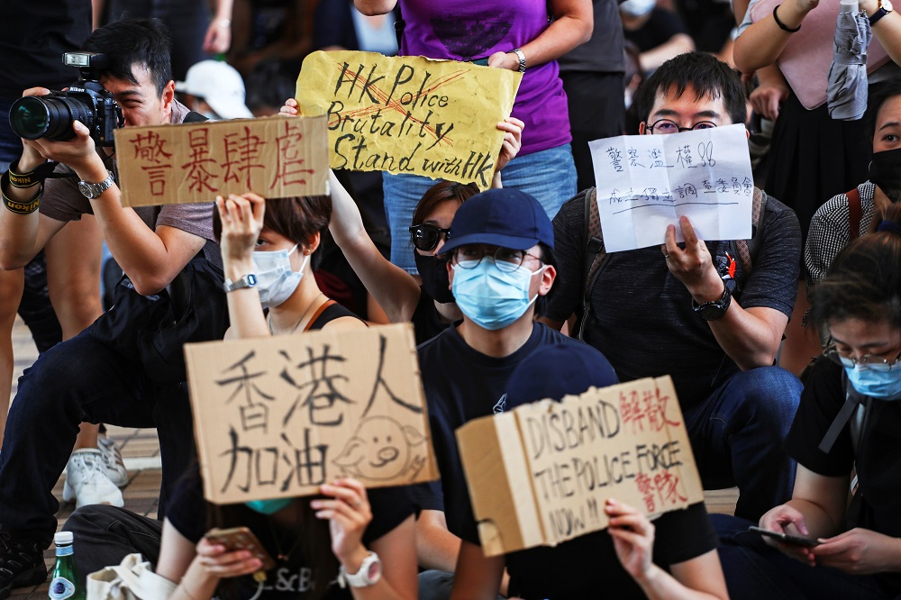 People hold up signs as they gather at West Kowloon Law Courts Building to show their support to 96 anti-government protesters who were arrested days ago in Hong Kong October 2, 2019. u00e2u20acu201d Reuters pic