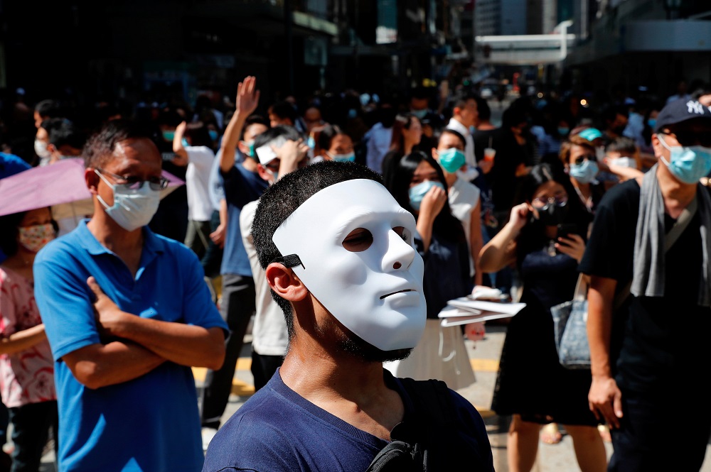 Anti-government office workers wearing masks attend a lunch time protest, after local media reported on an expected ban on face masks under emergency law, at Central, in Hong Kong October 4, 2019. u00e2u20acu201d Reuters pic