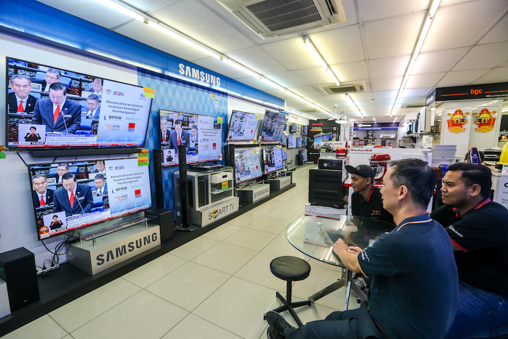 People watch a u00e2u20acu02dcliveu00e2u20acu2122 telecast of the tabling of Budget 2020 by Finance Minister Lim Guan Eng at an electronics shop in Kuala Lumpur October 11, 2019. u00e2u20acu201d Picture by Firdaus Latif