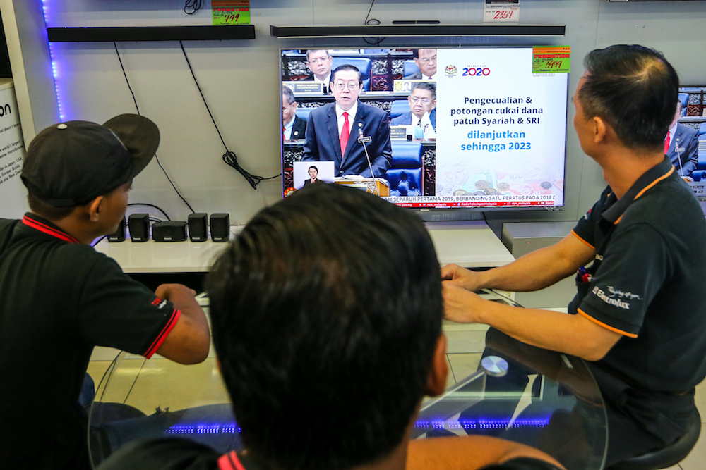 People watch a u00e2u20acu02dcliveu00e2u20acu2122 telecast of the tabling of Budget 2020 by Finance Minister Lim Guan Eng at an electronics shop in Kuala Lumpur October 11, 2019. u00e2u20acu201d Picture by Firdaus Latif