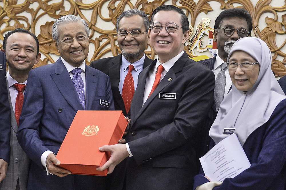 Prime Minister Tun Dr Mahathir Mohamad receives a copy of Budget 2020 from Finance Minister Lim Guan Eng in Parliament October 11, 2019. u00e2u20acu201d Picture by Miera Zulyana