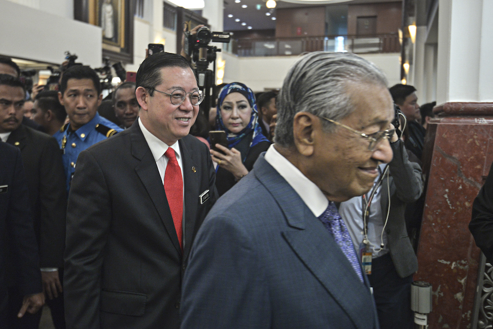 Finance Minister Lim Guan Eng and Prime Minster Tun Dr Mahathir Mohamad arrive in Parliament for the tabling of Budget 2020 on October 11, 2019. u00e2u20acu201d Picture by Shafwan Zaidon
