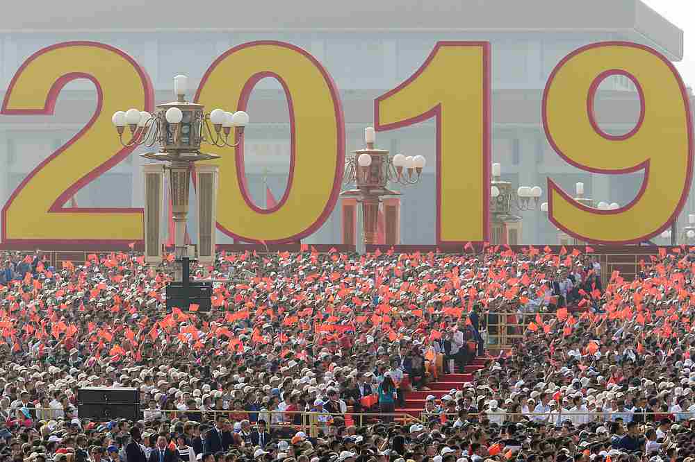 People wave Chinese flags before a military parade marking the 70th founding anniversary of People's Republic of China, on its National Day in Beijing October 1, 2019. u00e2u20acu201d Reuters pic