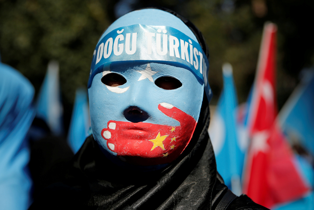 An ethnic Uighur demonstrator wears a mask as she attends a protest against China in front of the Chinese Consulate in Istanbul, Turkey, October 1, 2019. u00e2u20acu201d Reuters pic 
