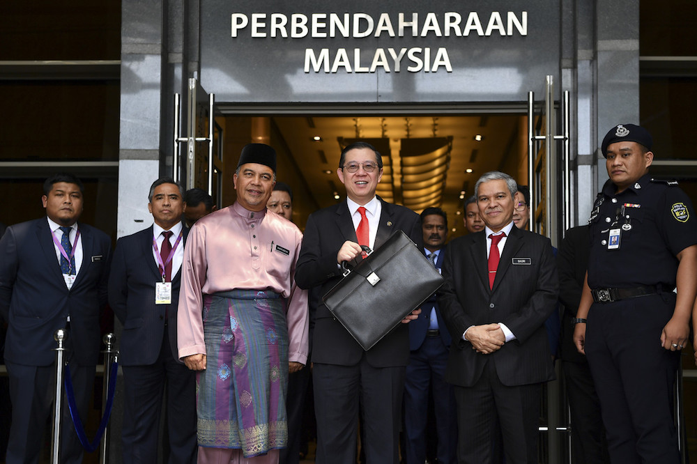 Finance Minister Lim Guan Eng holds up the briefcase with his Budget 2020 speech at the Finance Ministry in Putrajaya October 11, 2019. u00e2u20acu201d Bernama pic