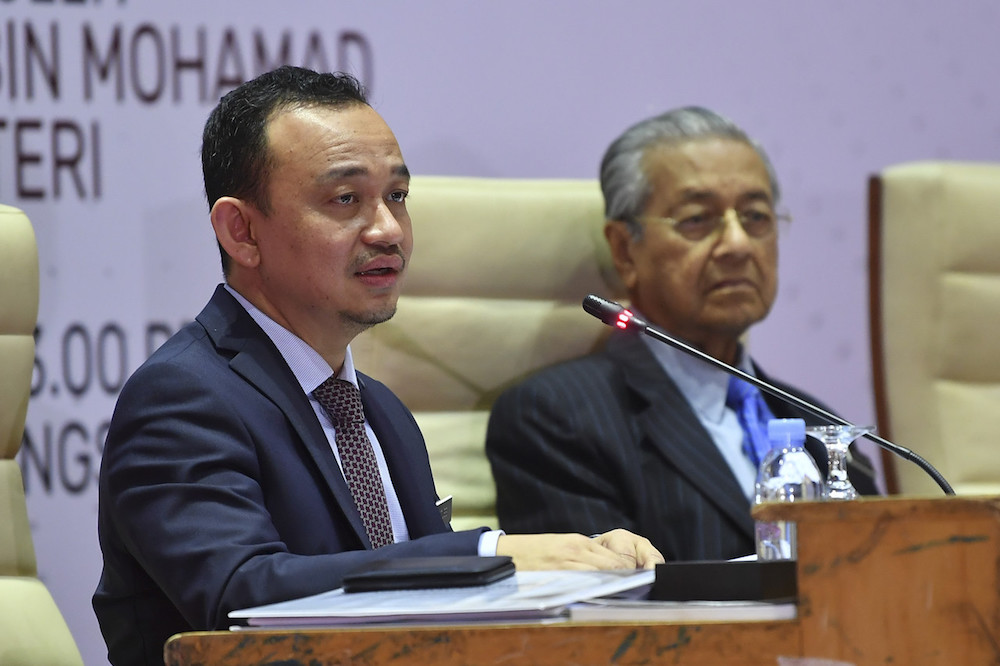 Prime Minister Tun Dr Mahathir Mohamad listens as Education Minister Maszlee Malik addresses the National Student Consultative Council 2019 in Putrajaya October 30, 2019. u00e2u20acu201d Bernama pic