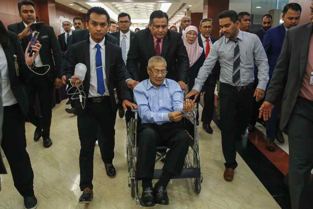 Nibong Tebal MP Datuk Mansor Othman is taken out on a wheelchair after he collapsed during the debate in Dewan Rakyat October 21, 2019. u00e2u20acu2022 Picture by Yusof Mat Isa