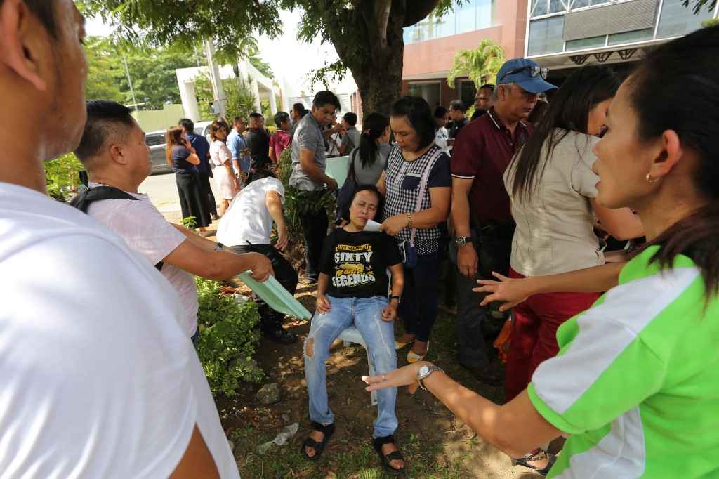 An office worker attended by colleagues after she fainted at the height of the earthquake that hit Davao City, in southern island of Mindanao October 29, 2019. u00e2u20acu201d AFP pic