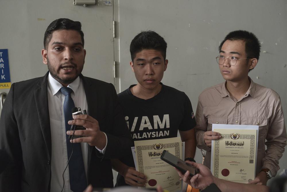 (From left) Lawyer Asheeq Ali, student activists Wong Yan Ke and Kon Hua En speak during a press conference outside University of Malayau00e2u20acu2122s examination hall in Kuala Lumpur October 19, 2019. u00e2u20acu2022 Picture by Shafwan Zaidon