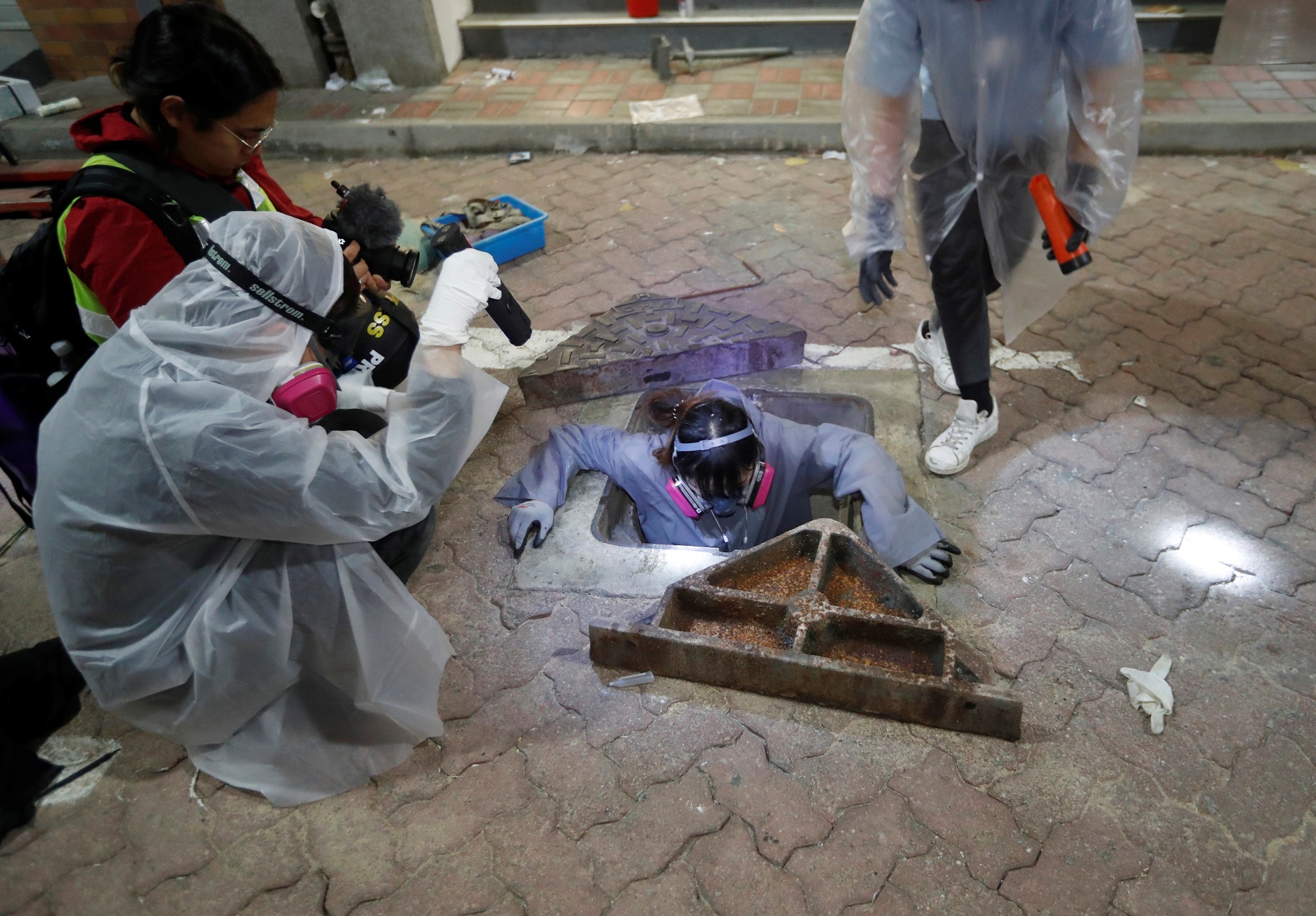 A protester tries to escape from a sewage tunnel inside the Hong Kong Polytechnic University campus during protests in Hong Kong, China, November 19, 2019. REUTERS/Adnan Abidi