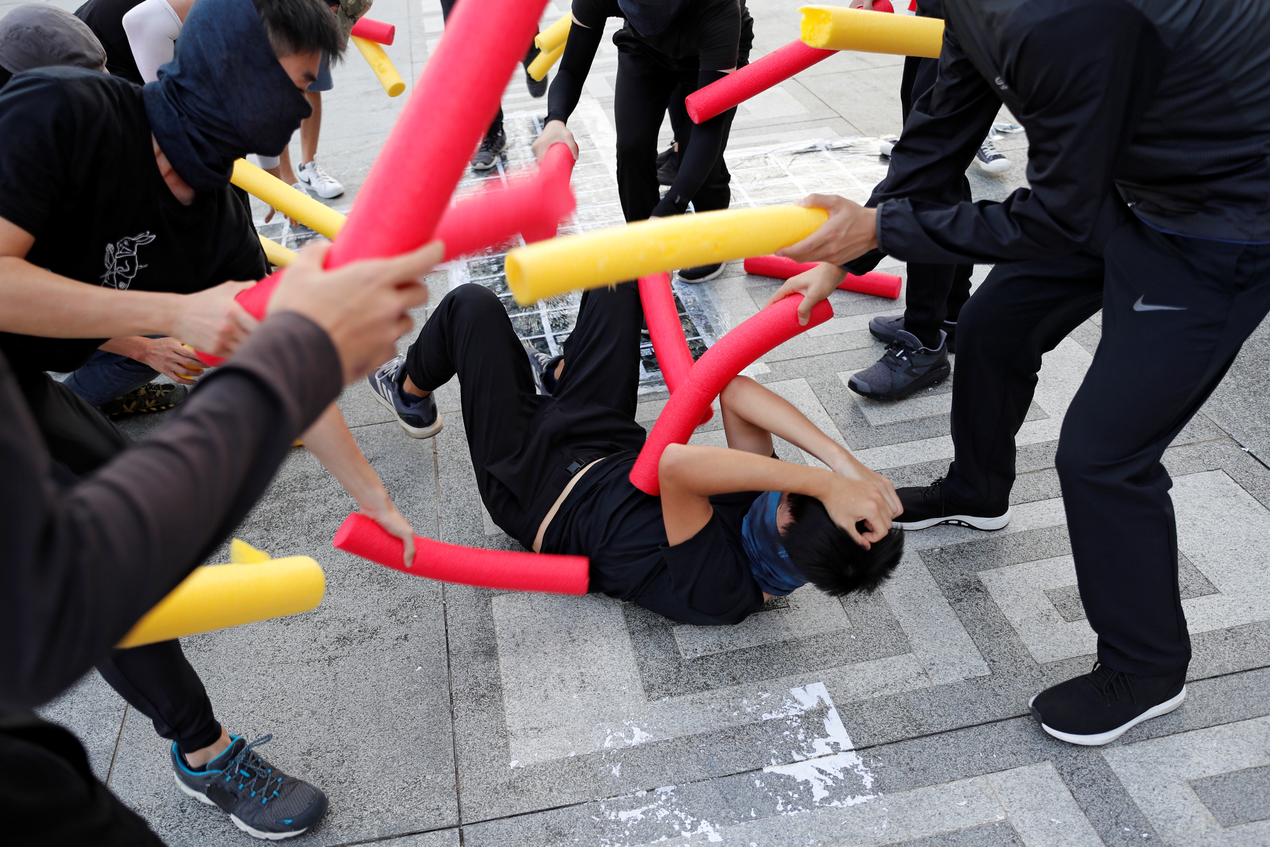 A participant is hit by others using foam sticks during a self-defence class organised by a student union at the Chinese University of Hong Kong October 15, 2019. u00e2u20acu201d Reuters pic
