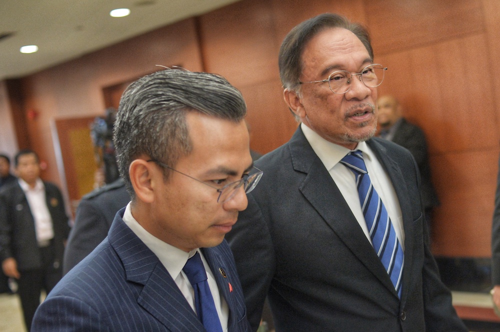 PKR president Datuk Seri Anwar Ibrahim and PKR communications chief Fahmi Fadzil leave after answering media questions at the Parliament building in Kuala Lumpur November 20, 2019. u00e2u20acu201d Picture by Shafwan Zaidon