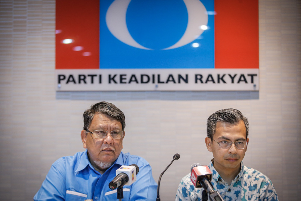 PKR Disciplinary Board chairman Datuk Ahmad Kasim and PKR communications director Fahmi Fadzil are seen during the press conference at PKR headquarters in Damansara on November 24, 2019. u00e2u20acu201d Picture by Hari Anggara