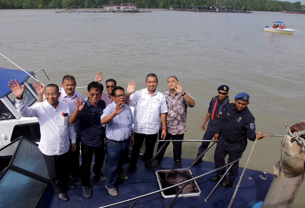 Johor Mentri Besar Dr Sahruddin Jamal (4th right) and Pakatan Harapan candidate for the Tanjung Piai by-election Karmaine Sardini (far left) during a visit to Kukup International Ferry Terminal November 1, 2019. u00e2u20acu201d Bernama pic