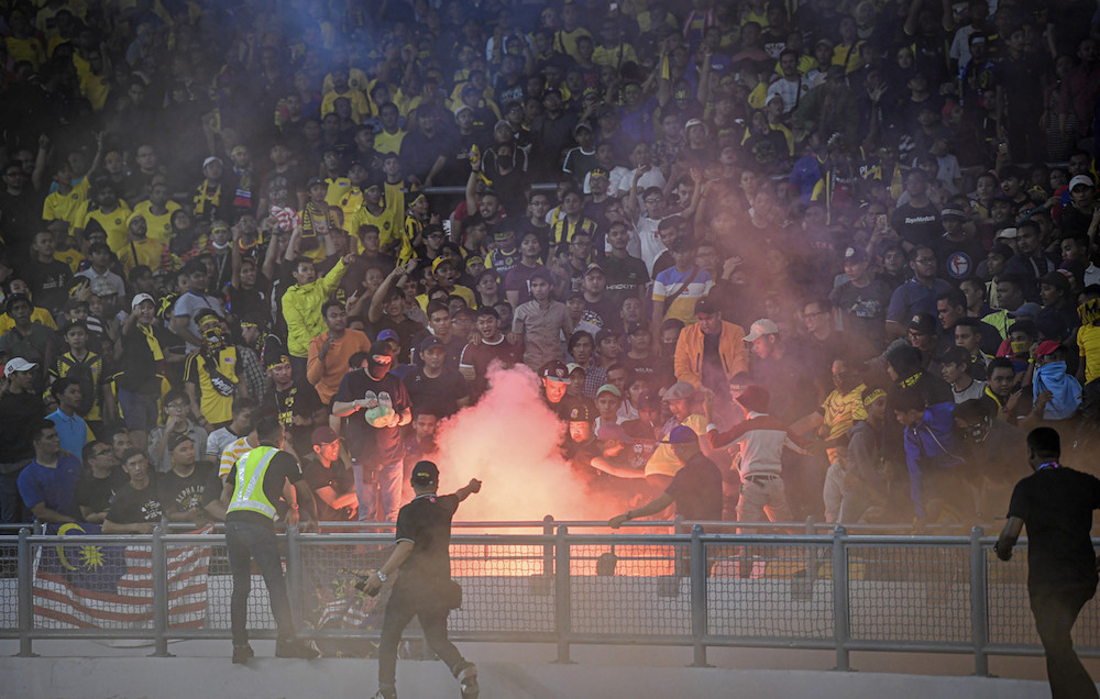 Fans clash during the Qatar 2022 Fifa World Cup qualifying match between Malaysia and Indonesia at Bukit Jalil Stadium November 19, 2019. u00e2u20acu201d Bernama pic