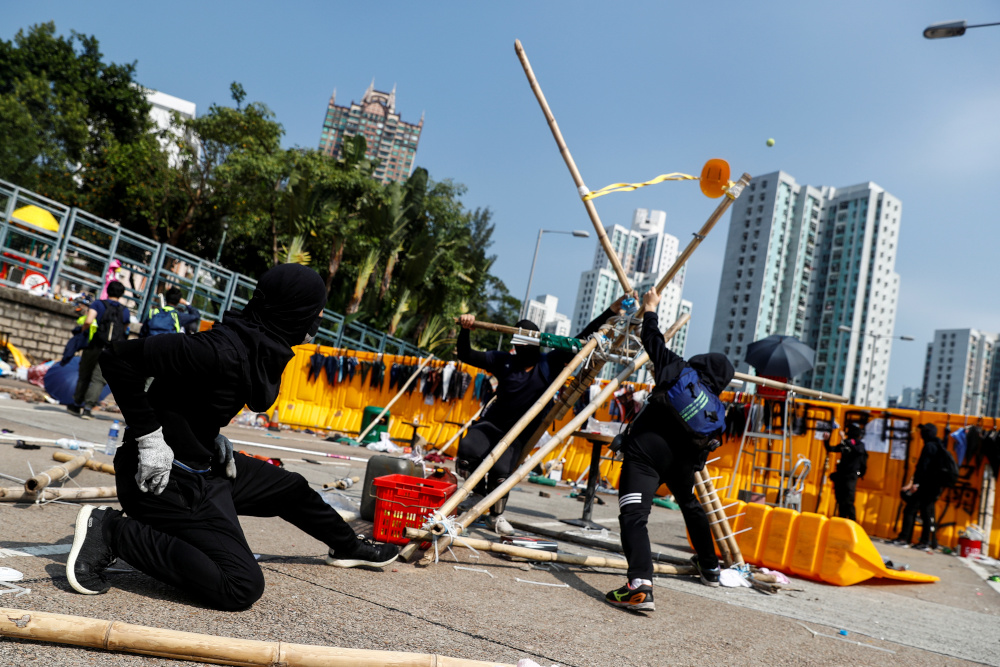 Student protesters use a giant improvised slingshot to fling tennis balls across a barricade as leisure at Hong Kong Baptist University, Hong Kong, China November 14, 2019. u00e2u20acu201d Reuters pic 