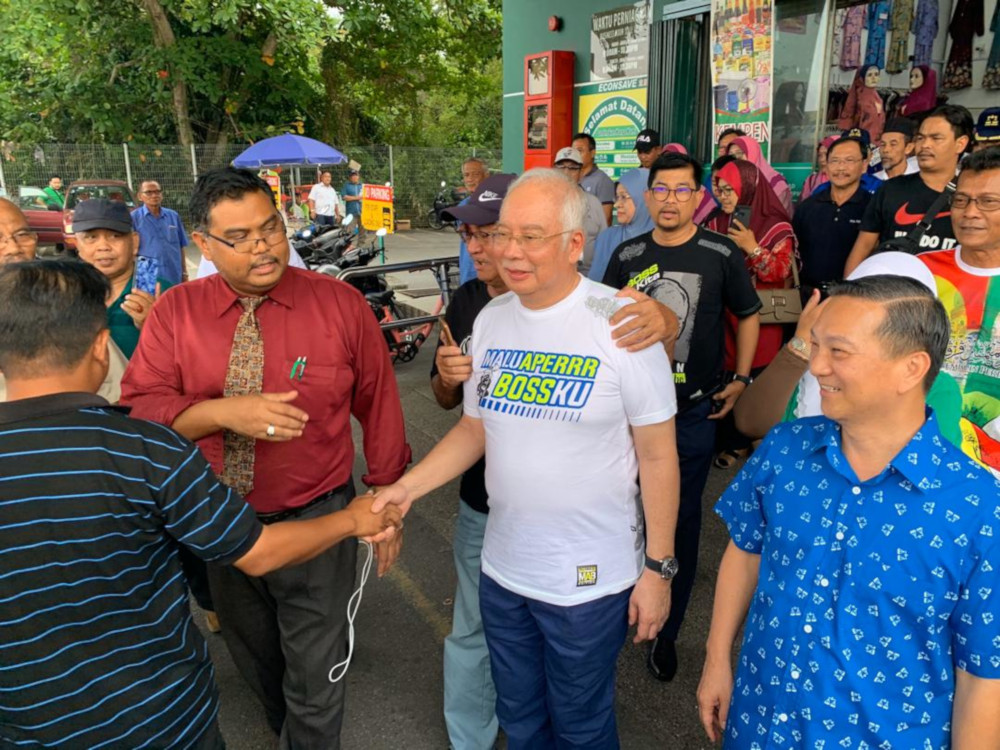 Former prime minister Datuk Seri Najib Razak greeting the crowd together BN Tanjung Piai by-election candidate Datuk Seri Wee Jeck Seng during a walkabout at Econsave supermarket in Pontian November 9, 2019. u00e2u20acu201d Picture by Ben Tan