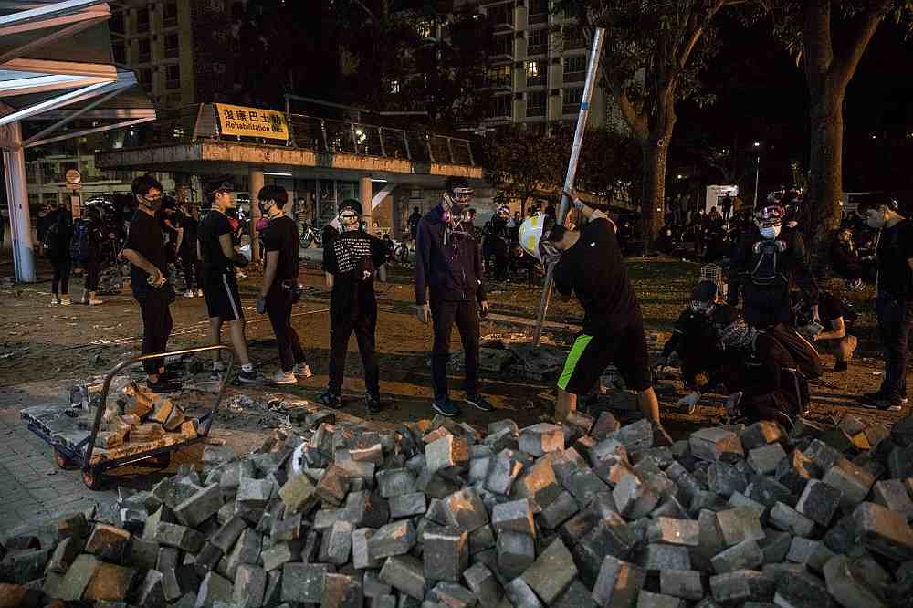 Protesters dig up paving bricks outside the MTR train station at the Chinese University of Hong Kong (CUHK) November 12, 2019. u00e2u20acu201d AFP pic