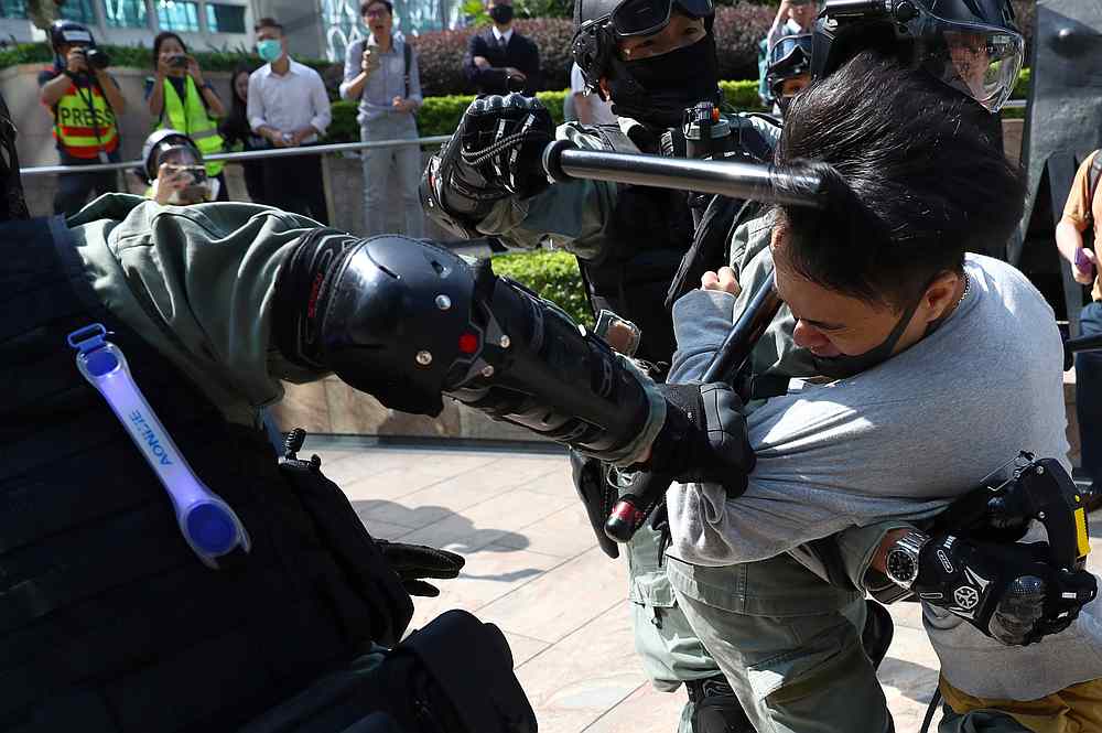An anti-government protester is struck in the head as he is being detained by riot police officers during a demonstration in the Central District in Hong Kong November 13, 2019. u00e2u20acu201d Reuters pic