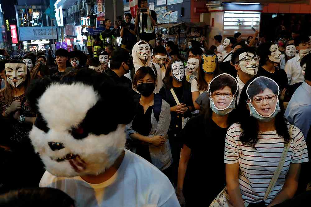 Anti-government protesters wear masks during a Halloween march in Lan Kwai Fong, Central district, Hong Kong October 31, 2019. u00e2u20acu201d Reuters pic