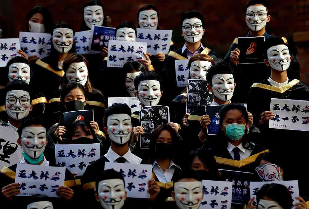 University students wearing Guy Fawkes masks pose for a photoshot to support anti-government protests before their graduation ceremony at the Hong Kong Polytechnic University in Hong Kong November 5, 2019. u00e2u20acu201d Reuters pic