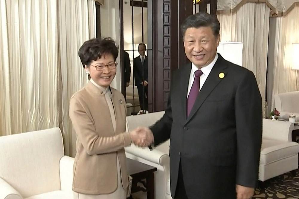 Chinese President Xi Jinping (right) and Hong Kong Chief Executive Carrie Lam shake hands during their meeting in Shanghai November 4, 2019. u00e2u20acu201d China Central Television (CCTV) handout via AFP