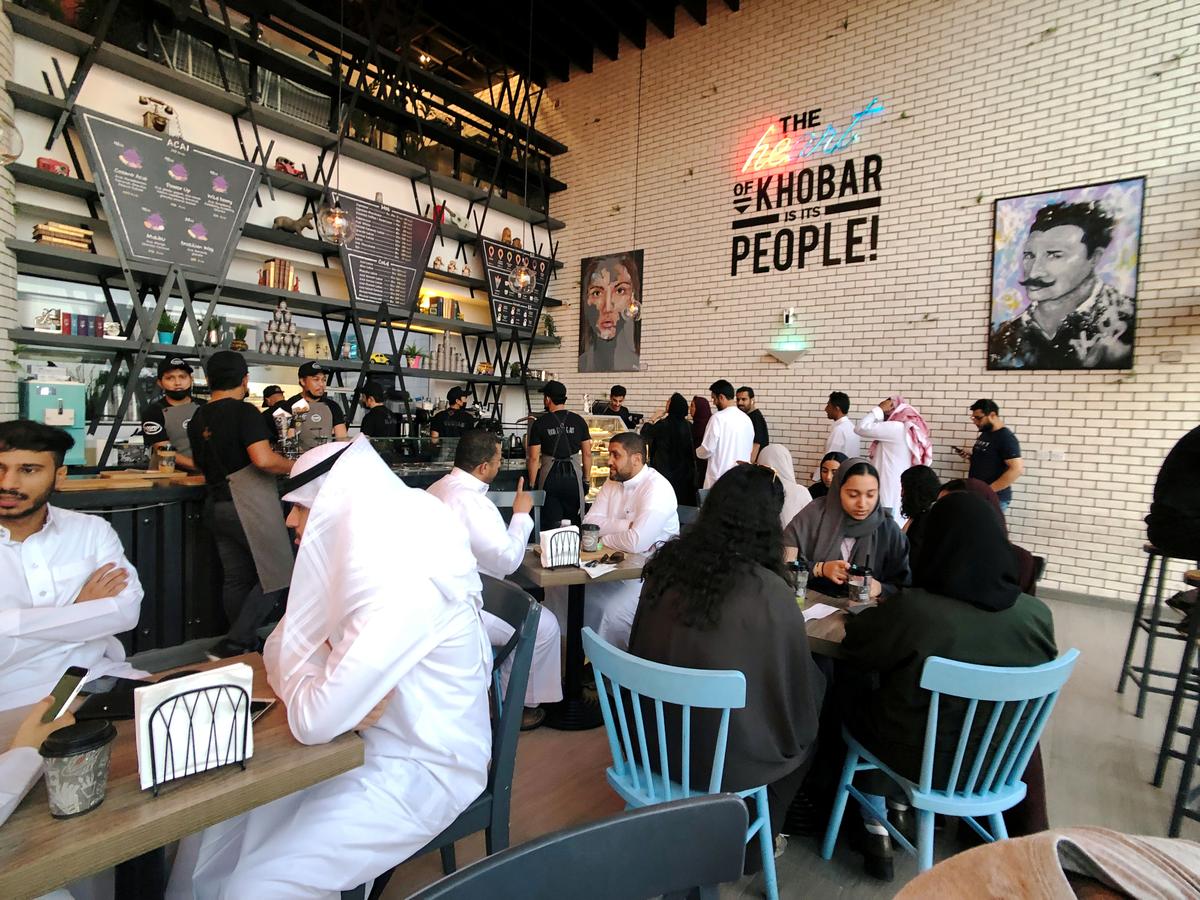 FILE PHOTO: Women sit among men in a newly opened cafe in Khobar, Saudi Arabia, August 2, 2019. REUTERS/ Hamad I Mohammed/File Photo