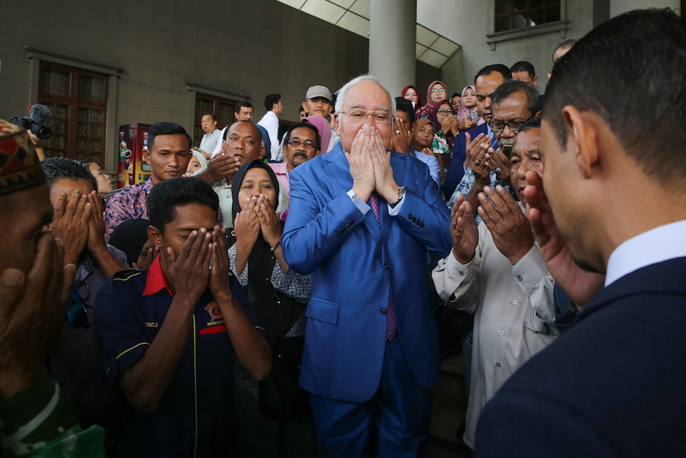 Former prime minister Datuk Seri Najib Razak prays with supporters at the Kuala Lumpur Courts Complex December 3, 2019. u00e2u20acu201d Picture by Yusof Mat Isa