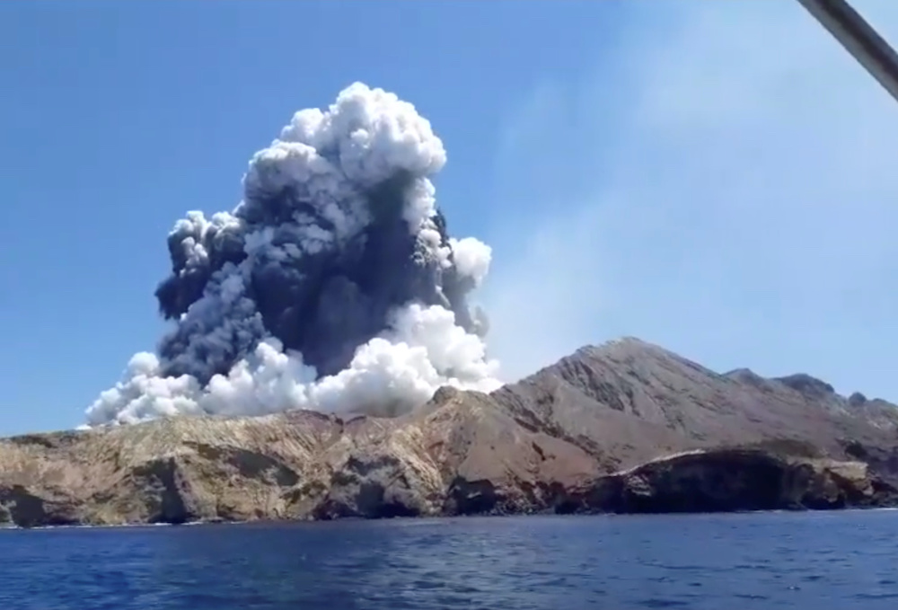 Smoke from the volcanic eruption of Whakaari, also known as White Island, is pictured from a boat, New Zealand December 9, 2019 in this picture grab obtained from a social media video. u00e2u20acu201d Instagram pic via Reuters