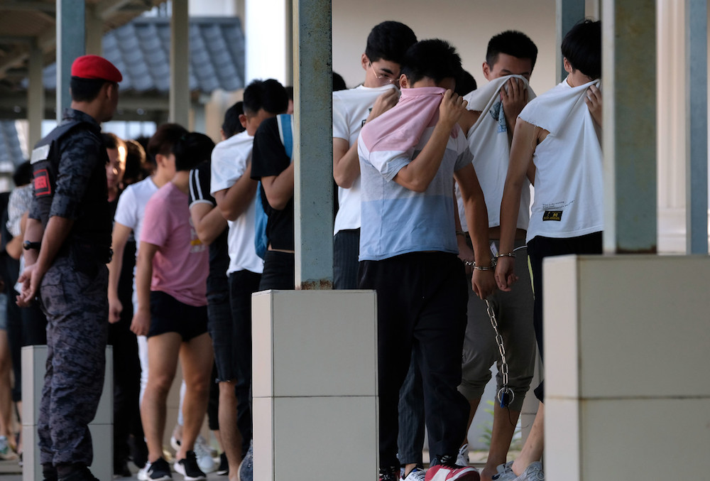 Some of the Chinese nationals who were arrested on suspicion of being involved in an illegal online scam are seen at the Sessions Court in Sepang December 13, 2019. u00e2u20acu201d Bernama pic