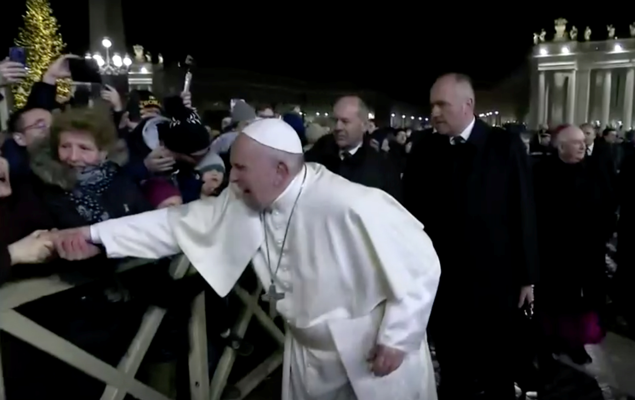 A woman grabs Pope Francis' hand and yanks him towards her at Saint Peter's Square at the Vatican December 31, 2019. u00e2u20acu201d Vatican Media handout via Reuters
