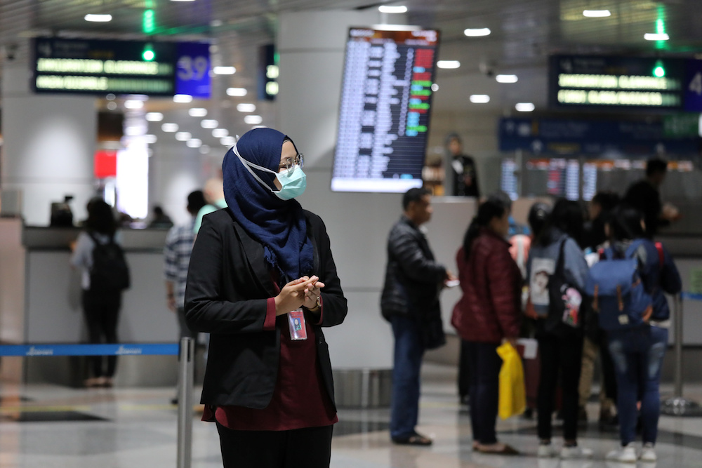 An aviation officer wears a mask at Kuala Lumpur International Airport in Sepang January 21, 2020. u00e2u20acu201d Reuters pic